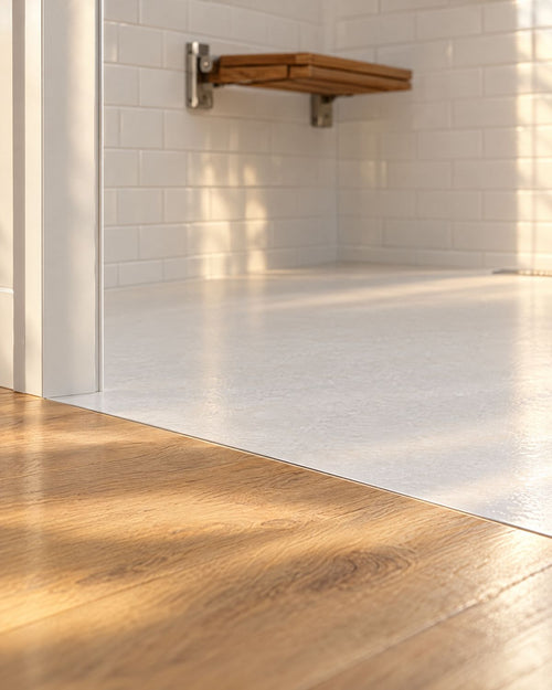 Level, curbless entry from a wood floor into a walk-in shower