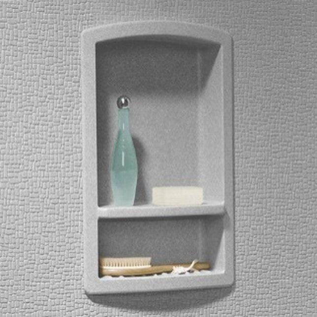 Recessed two-compartment shampoo shelf set into a gray shower wall