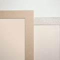 Corner detail of solid-surface wall trim in sand and gray